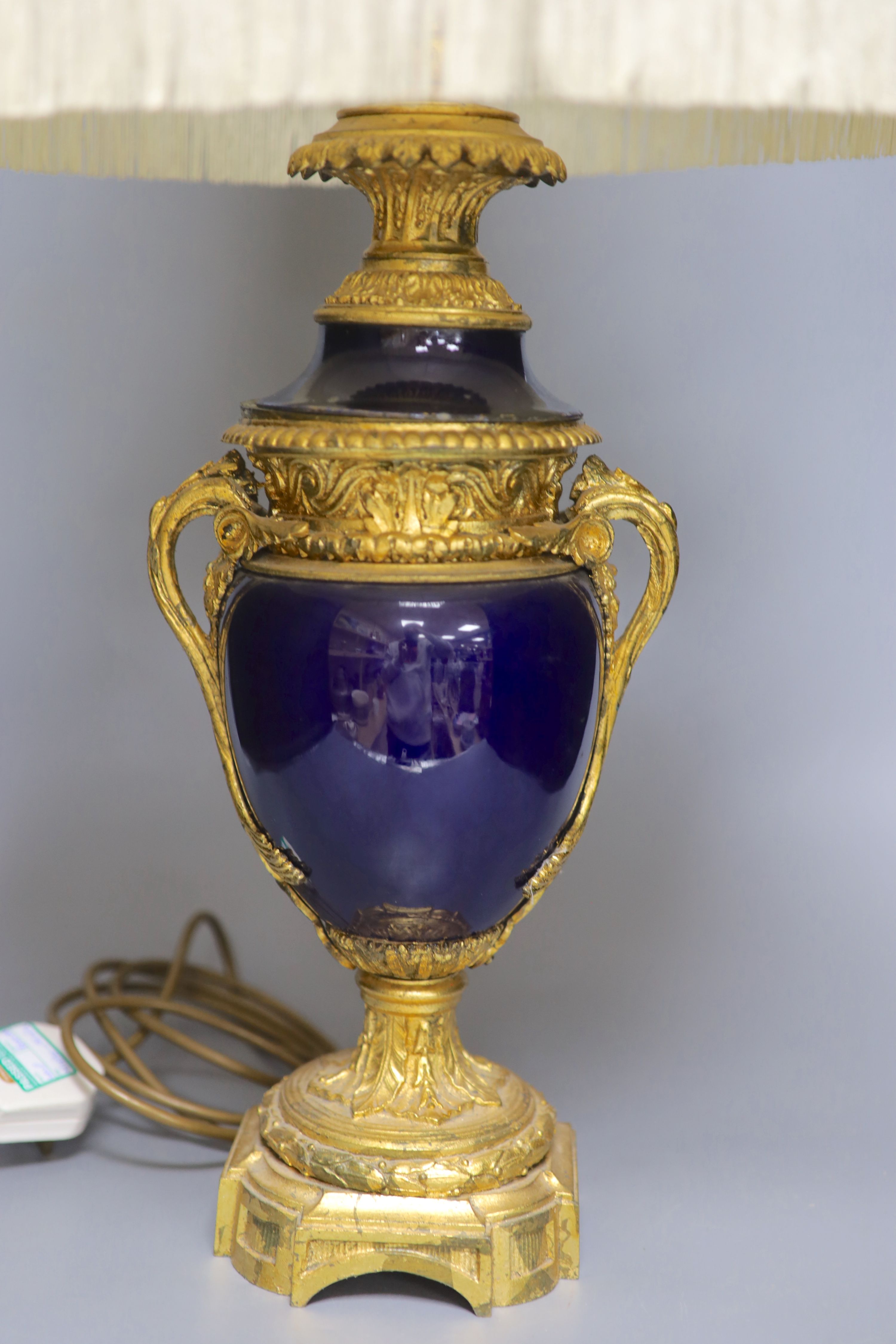 A French gilt metal and porcelain table lamp